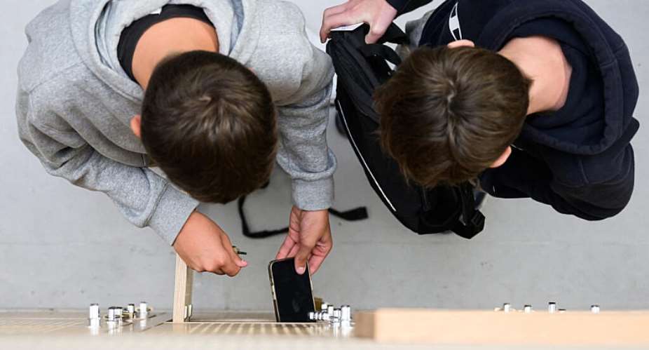 Pupils put their phones in their lockers after switching them off at the Auguste Brizeux high school in Lorient, western France, where this is mandatory. As of September, all French high schools will be required to put in place rules banning phones. -  Loic Venance/AFP