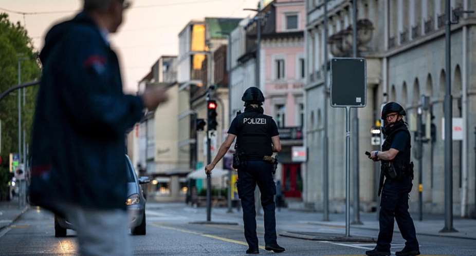 Police officers patrol a street in downtown Aarau, Switzerland Sunday, August 30, 2026, following a shooting at a rave. -  Michael Buholzer/Keystone via AP