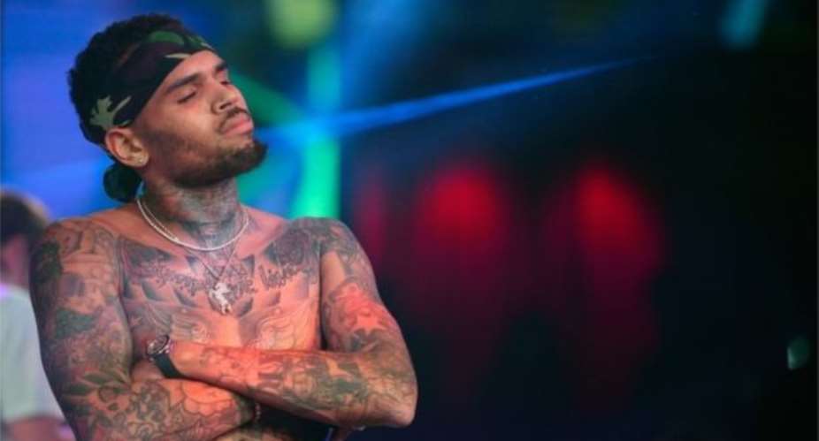 Singer Chris Brown arrested for pointing gun at woman