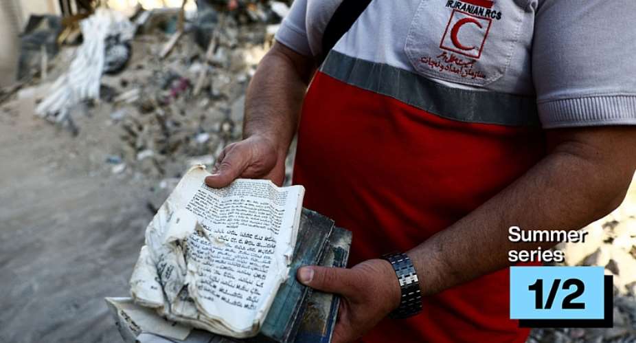 A member of the Iranian Red Crescent holds the Torah at a synagogue which was damaged in a strike amid the US-Israeli conflict, Tehran, Iran, April 7, 2026. -  Majid Asgaripour, Reuters