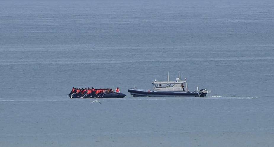 FILE - A boat carrying migrants is escorted by a vessel from the French Gendarmerie Nationale in the English Channel off Wimereux beach, France, on September 4, 2024. -  Nicolas Garriga, AP