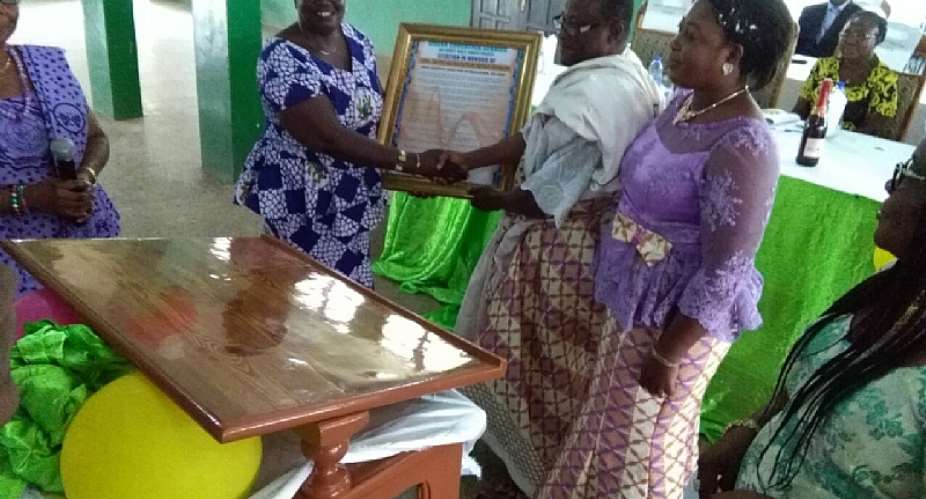 Mr. Ayivi-Tosuh receiving a citation from staff of the Ho West District Education Directotrate