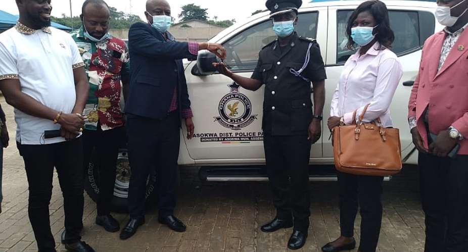 Asokwa MCE,  Chief Akwannuasah Gyimah presenting keys to the pickup vehicle to Chief Superintendent Christopher Owusu Mpianin, Asokwa District Police Command
