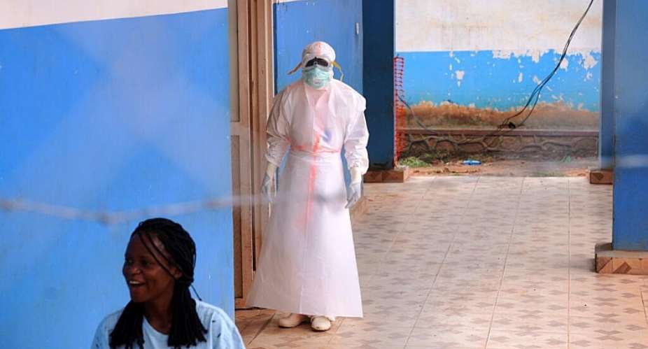 A health worker wearing protective gear stands outside the Ebola Treatment Center at the Bunia General Hospital in Ituri, Congo, on July 22, 2026. -  Dirole Lotsima Dieudonn, AP