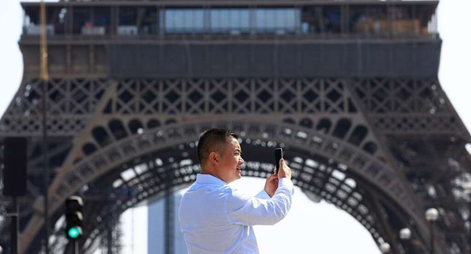 A file image of a person using his phone near the Eiffel Tower in Paris on August 31, 2022. -  Aurelien Morissard, AP