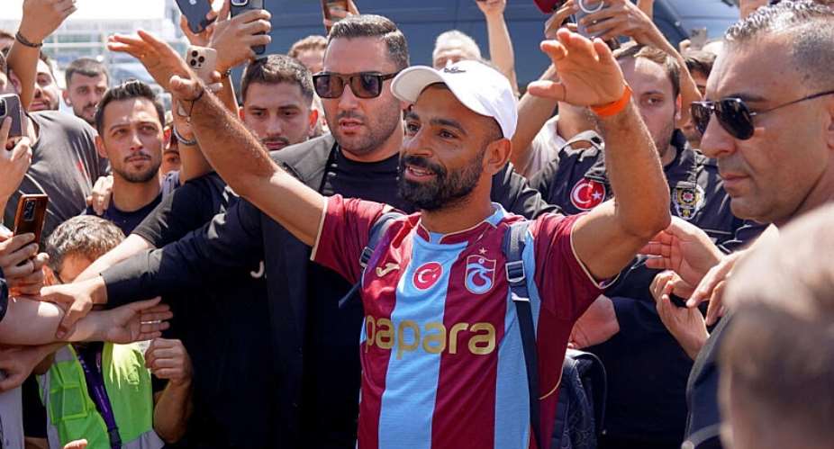 Egypts Mohamed Salah wearing his new Trabzonspor team jersey gestures to supporters as he arrives at the airport in Istanbul, Turkey, on August 5, 2026. -  Samet Yalcin, Dia Photo via AP