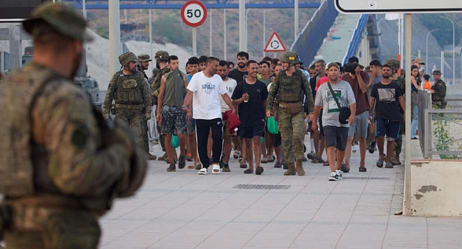Escorted by the Spanish army, migrants who crossed into Spain return to Morocco from the Spanish enclave of Ceuta on Saturday, 1 August, 2026. - AP Photo/Antonio Sempere - Antonio Sempere