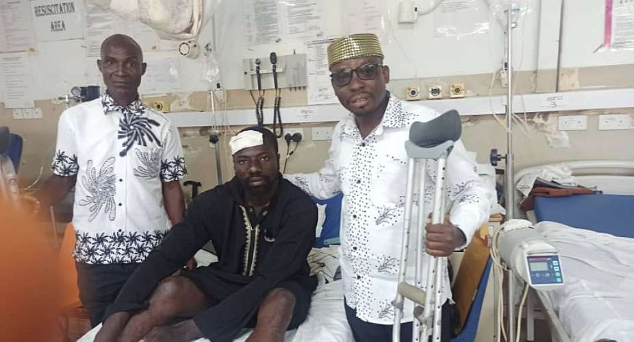 Effutu Communication Director right with the victim on a hospital bed