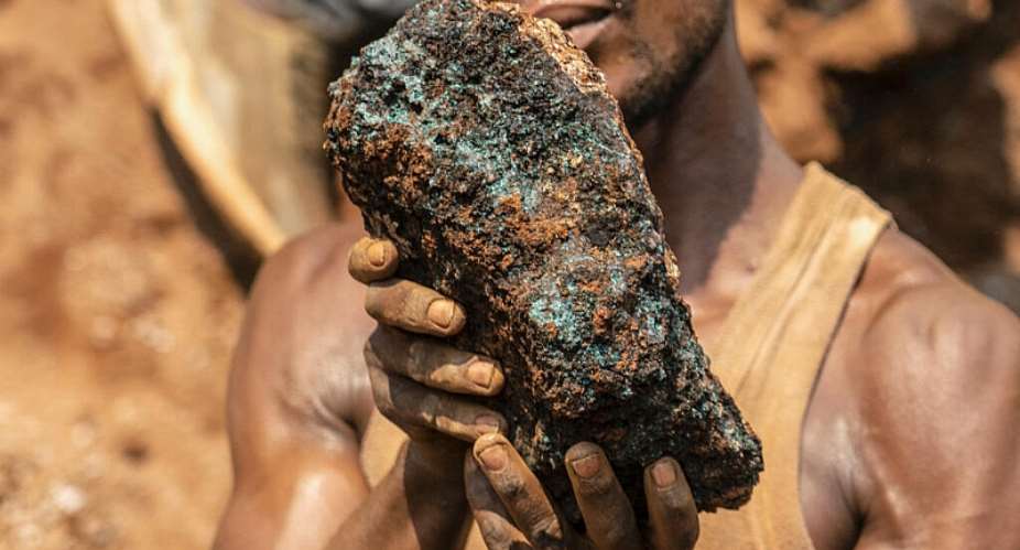 An artisanal miner holding a cobalt stone at the Shabara artisanal mine near Kolwezi, in Katanga, in October 2022. -  AFP/Junior Kannah