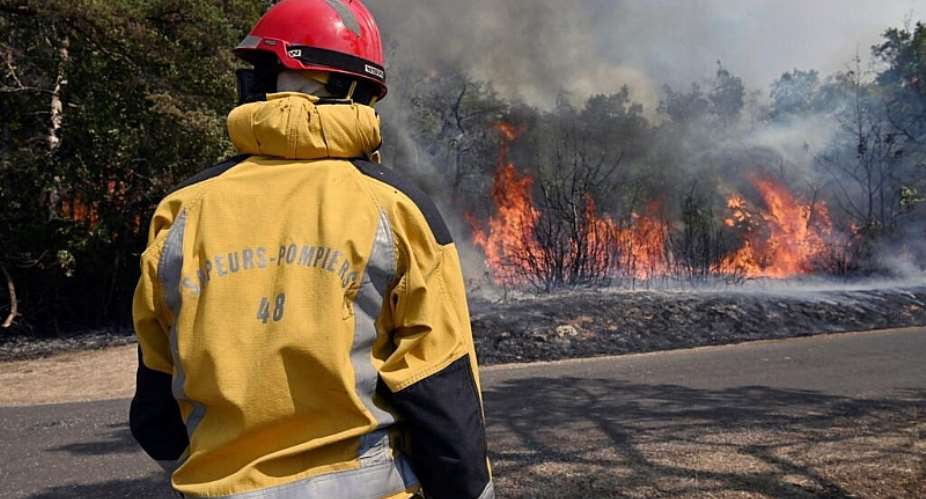 File photo: A firefighter, whose jacket bears the number of the Lozere department, works to extinguish a fire in Boyne, southern France, on August 9, 2022, as a wildfire is underway in the Grands Causses natural park. - AFP - PASCAL GUYOT