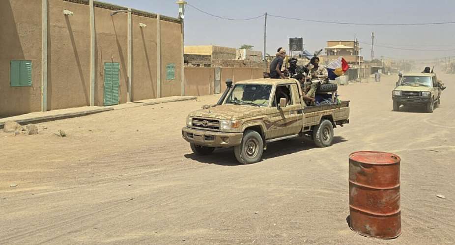 Tuareg rebels from the Azawad Liberation Front (FLA) coalition ride in the back of a pick-up truck in Kidal, Mali, on 26 April 2026. -  AFP