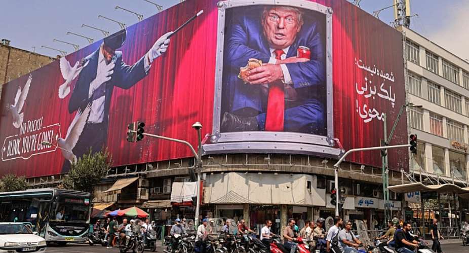 Motorists ride past a billboard depicting US President Donald Trump inside a catering container, installed on a building along a street in downtown of Tehran on August 31, 2026. -  Atta Kenare, AFP