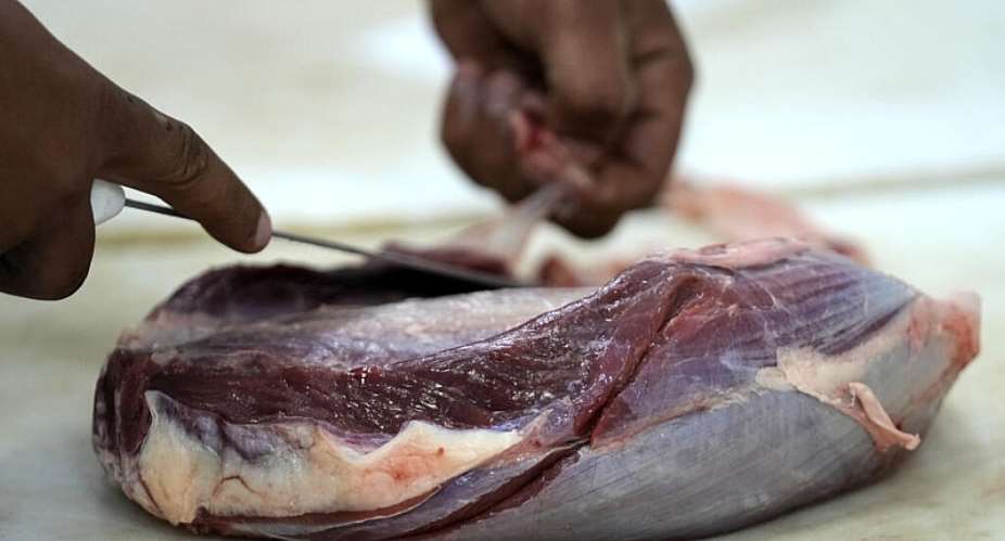 An employee prepares cuts of meat in a butcher shop, in Brasilia, Brazil, Monday, Aug. 4, 2025. -  Eraldo Peres, AP