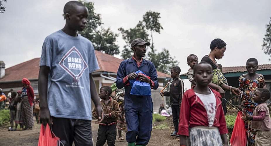 Children from Kibumba carry their school supplies home after a distribution by the women-led NGO Woman Power DRC ahead of the school reopening in Kibumba, on 28 August, 2025. -  JOSPIN MWISHA / AFP