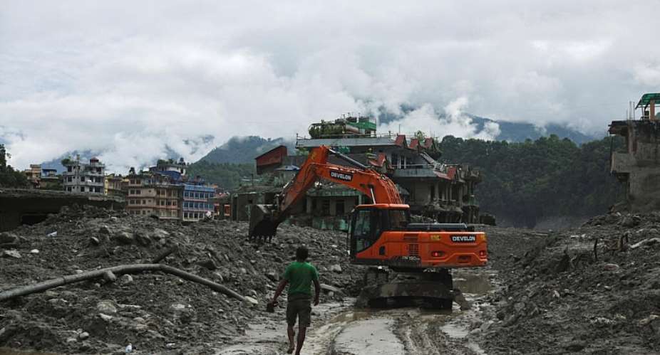 An excavator clears a muddy path after flash floods and a mudslide in Trishuli, Nuwakot district, Nepal, 1 September, 2026. -  Reuters/Francis Mascarenhas