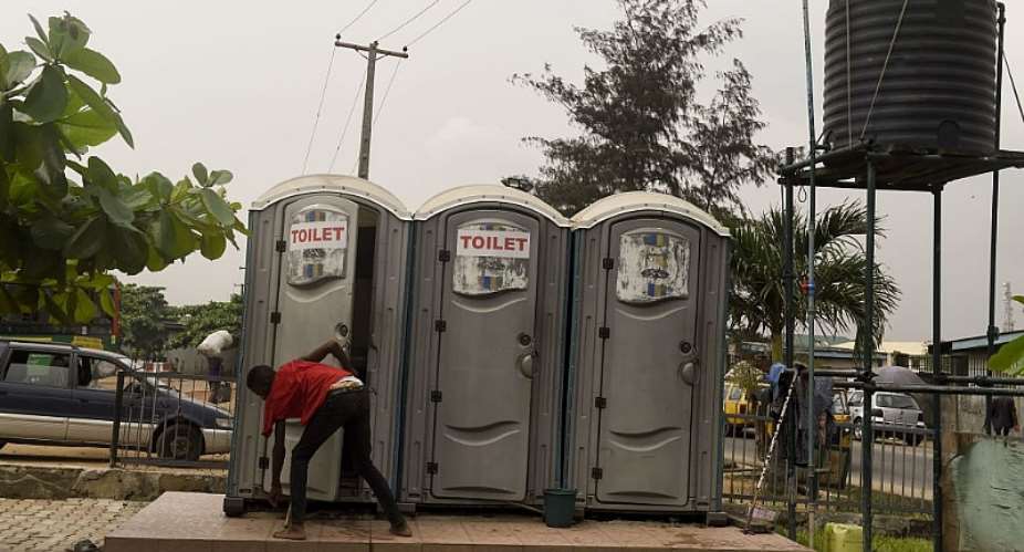 A boy leaves mobile and portable public toilet at Ketu in Lagos. - Source: AFP via Getty Images/ Pius Utomi Ekpei