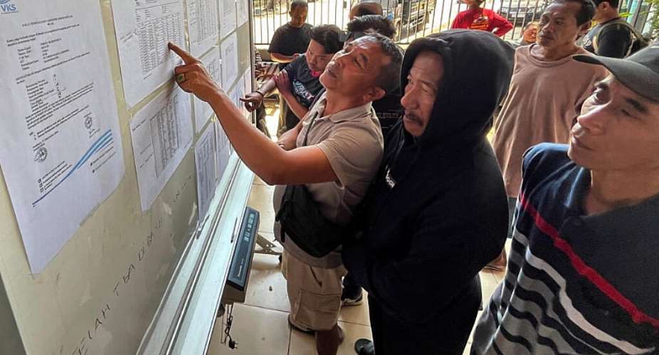 People check the passenger manifest of Virgo Transport 8 ferry at a rescue command center in Banjarmasin, Indonesia, September 14, 2026. -  Iman Satria, AP