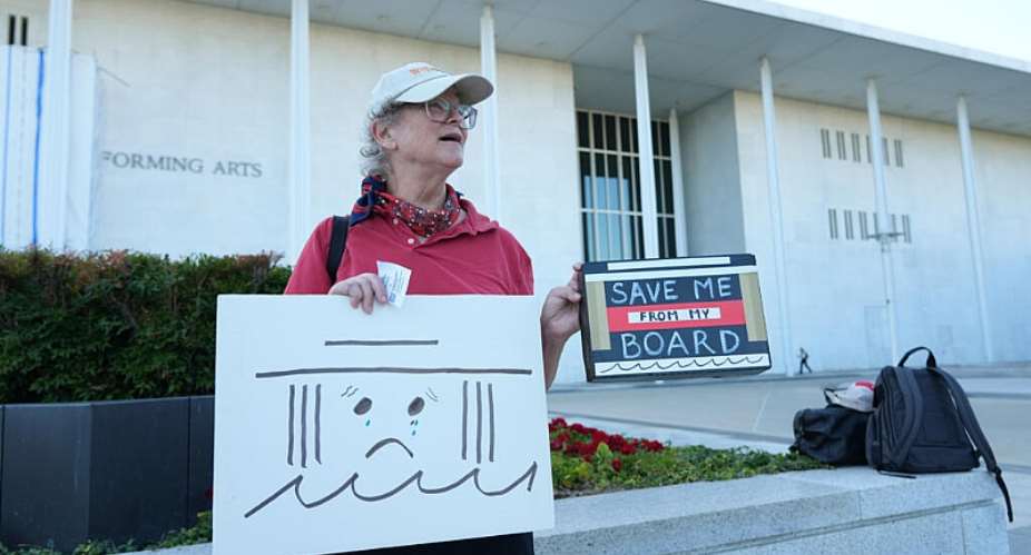 Laura Bligh holds a sign outside the John F. Kennedy Center for the Performing Arts in Washington on September 15, 2026. -  Jacquelyn Martin, AP
