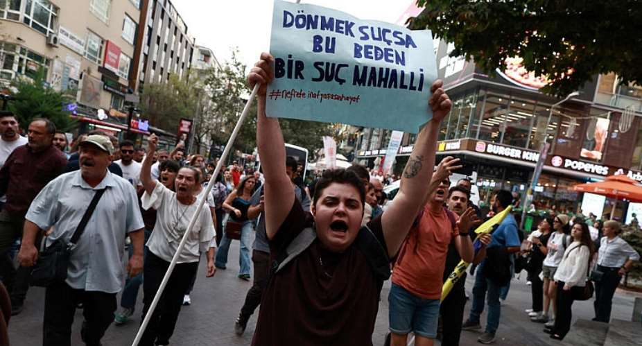 A protester holds a placard reading, If changing gender is a crime, then this body is a crime scene, during a demonstration against the Turkish governments crackdown on LGBTQ+ groups in Ankara on 15 September 2026. - REUTERS - Efekan Akyuz