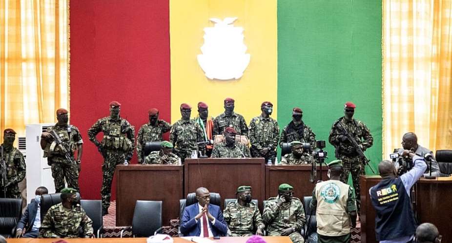 Colonel Mamady Doumbouya C and his team of Guinean special forces listen as he holds talks with religious leaders at the Peopleamp;39;s Palace in Conakry on September 14, 2021.  - Source: JOHN WESSELSAFP via Getty Images