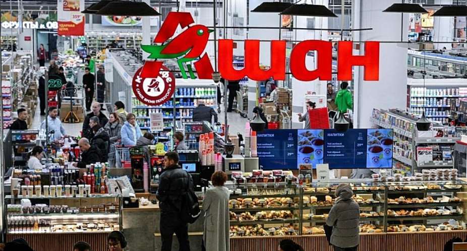 Customers shop for food in an Auchan supermarket in Aviapark shopping mall in Moscow on February 11, 2026. -  Hector Retamal, AFP