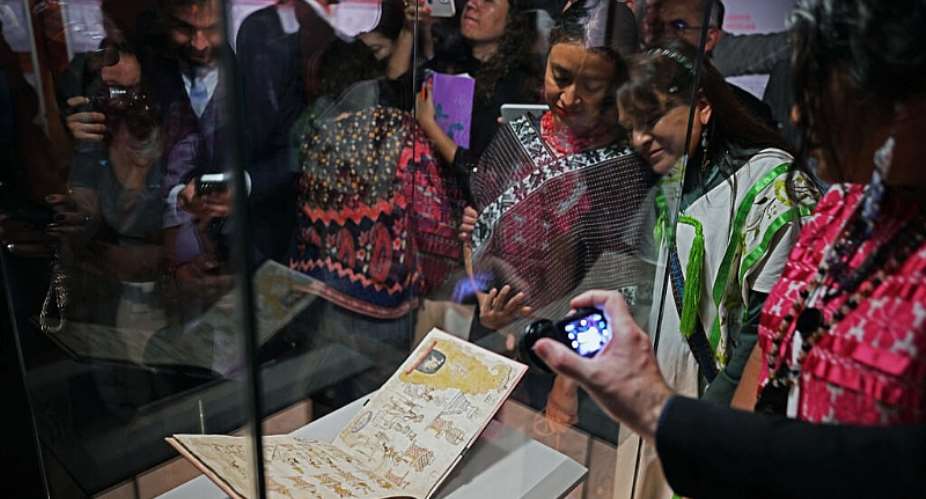 Attendees look at the Azcatitlan Codex, an ancient Aztec pictorial manuscript on loan from France, at the National Museum of Anthropology in Mexico City on September 17, 2026. -  Carl de Souza, AFP