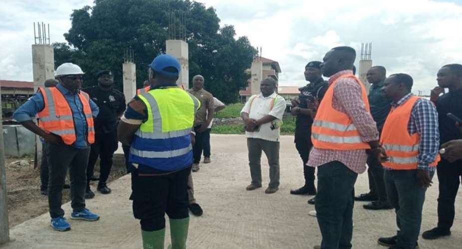 HON. ANTWI (LEFT) INTERACTING WITH OFFICIALS AT THE NEW KOKROMPE SHS