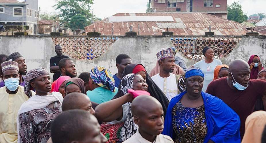 Families of illegal mining suspects who died while in detention gather outside the Minna General Hospital, where the bodies were taken. - REUTERS - Ibrahim Ndamitso