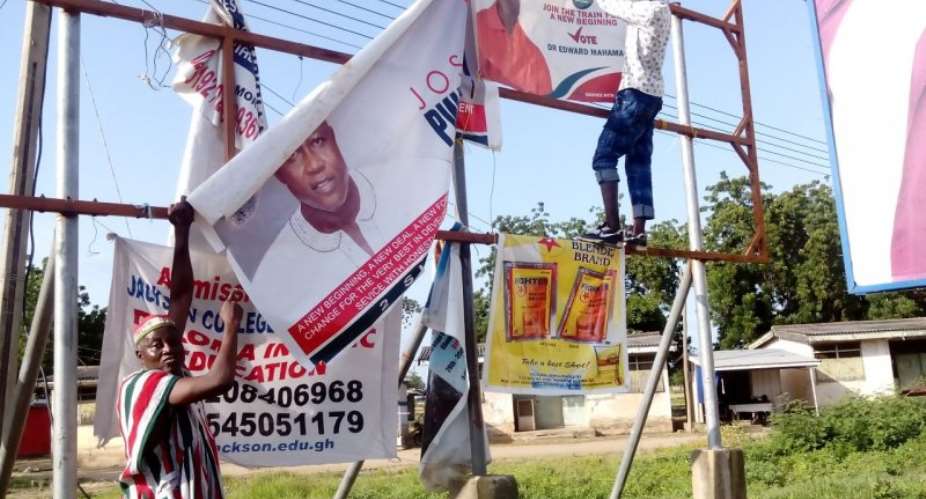 PNCs parliamentary candidate for Navrongo Central, Pwoawuvi Joseph Weguri, showing one of the destroyed campaign banners to the press