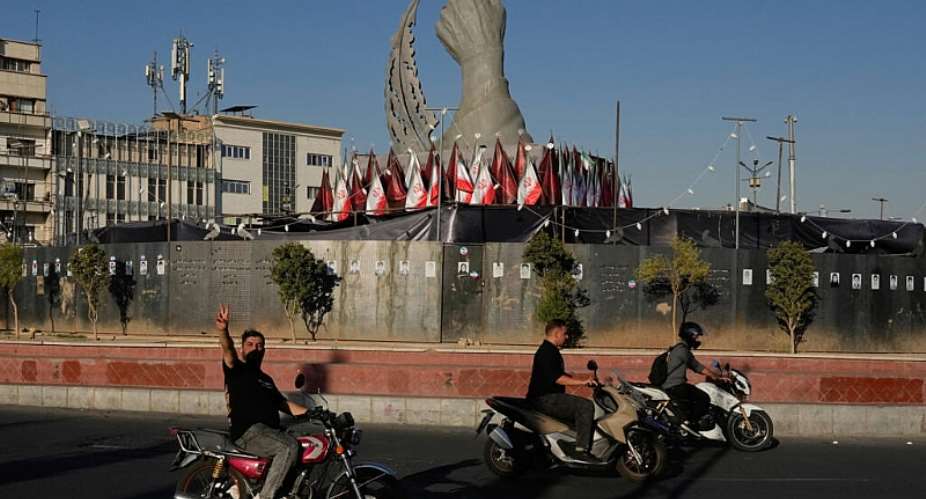 A motorist reacts while driving past a monument depicting the clenched fist of the late Iranian Supreme Leader Ayatollah Ali Khamenei in Tehran, Iran, September 15, 2026. -  Vahid Salemi, AP