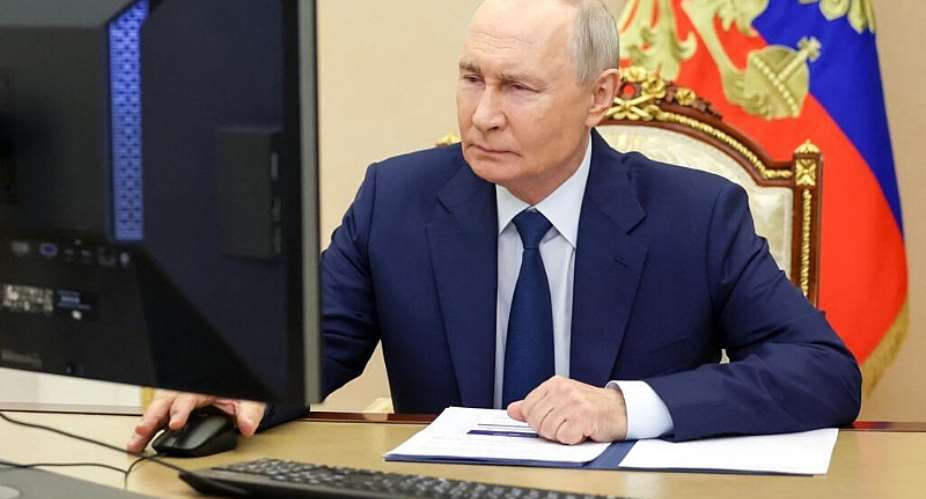 In this pool photograph distributed by the Russian state agency Sputnik, Russias President Vladimir Putin votes online in the parliamentary election in Moscow on September 18, 2026. - AFP - VYACHESLAV PROKOFYEV