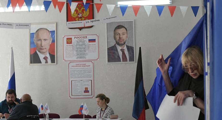 A woman leaves a voting booth during Russias parliamentary election at a polling station in Donetsk, Russian-controlled Ukraine, on September 20, 2026, amid the ongoing Russian-Ukrainian conflict. -  stringer, AFP