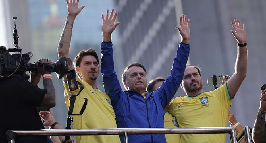 Former president Jair Bolsonaro, centre, waves to the crowd alongside his sons Jair Renan Bolsonaro (left) and Carlos Bolsonaro (second right), during a demonstration against his trial at the Court of Justice of the Republic, So Paulo, Sunday, June 29, 2025. -  Ettore Chiereguini, AP