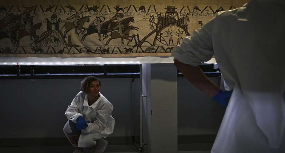 Workers and volunteers rest before preparing to pack the Bayeux tapestry to transfer to the British Museum, at the Bayeux Tapestry Museum, in Bayeux, northwestern France, Thursday, September 18, 2025. -  Lou Benoist, AP