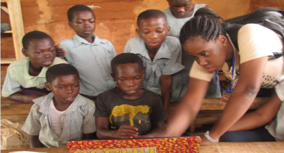 Josephine teaching digital literacy skills to child beneficiaries of her social enterprise, Young at Heart GH.