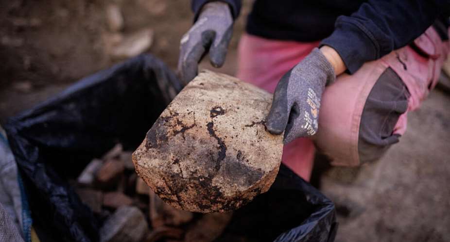 Elodie Perugini, an archeologist with the city of Paris, holds a Gallic wine amphora piece during excavations at an archaeological site on the Ile de la Cit in Paris on September 23, 2026. -  Simon Wohlfahrt, AFP