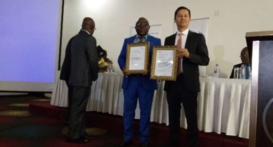 Mr. Kakari Addo middle displaying the certificates alongside UNIDO Project Manager, Pablo
