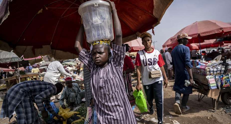 A boy carries drinking water for sale at a street market in Abuja, Nigeria. Scientists estimate Nigeria could face the worlds highest heat-related death toll from the current El Nino. - AP - Ben Curtis