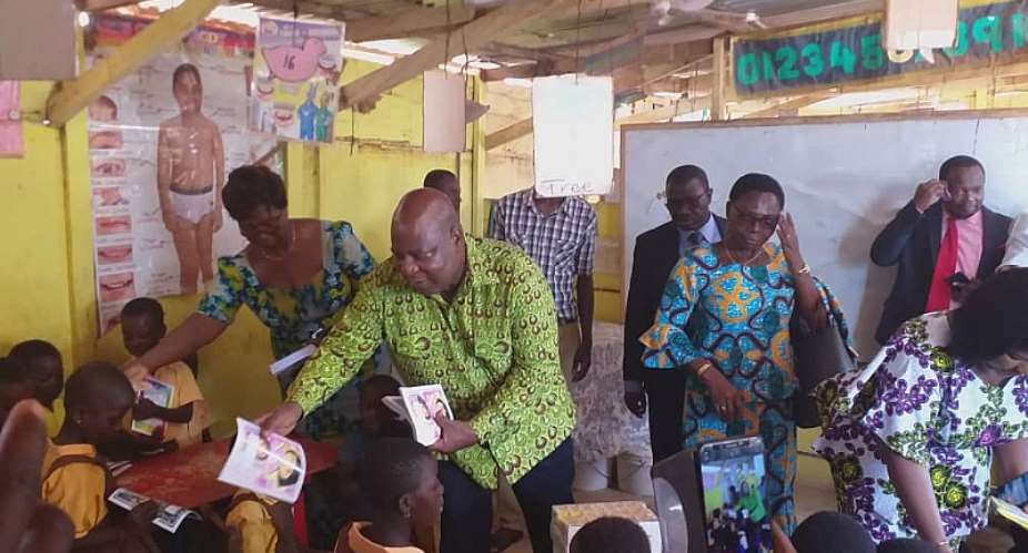 The Greater Accra Regional Minister, Hon. Ishmael Ashitey Distributing the Books to the School Children
