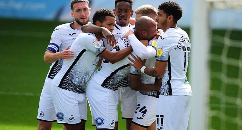 Andre Ayew celebrating his goal against Wycombe with his Swansea City teammates