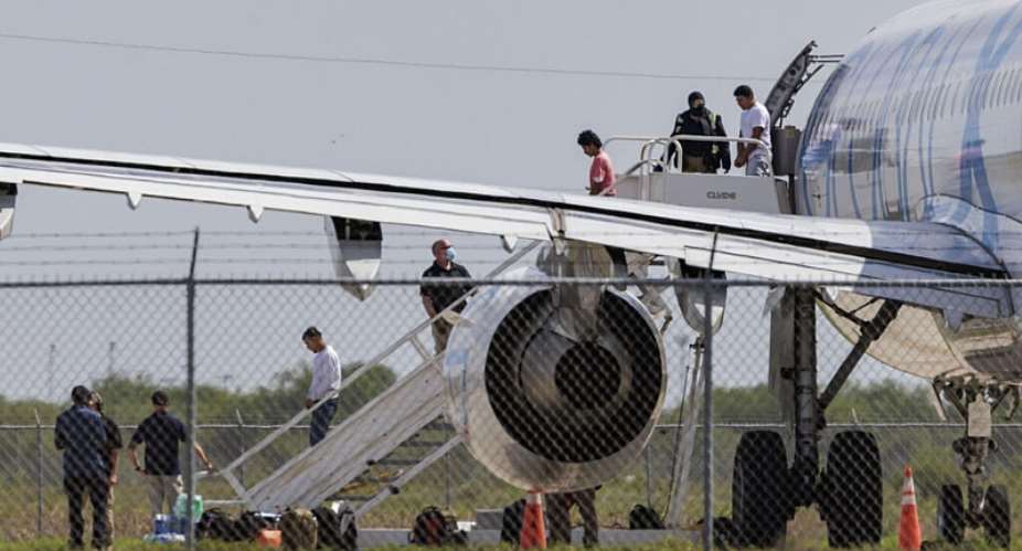 Shackled migrants deplane an aircraft used for deportation flights at the Valley International Airport in Texas, in August 2025. -  Michael Gonzalez, AP