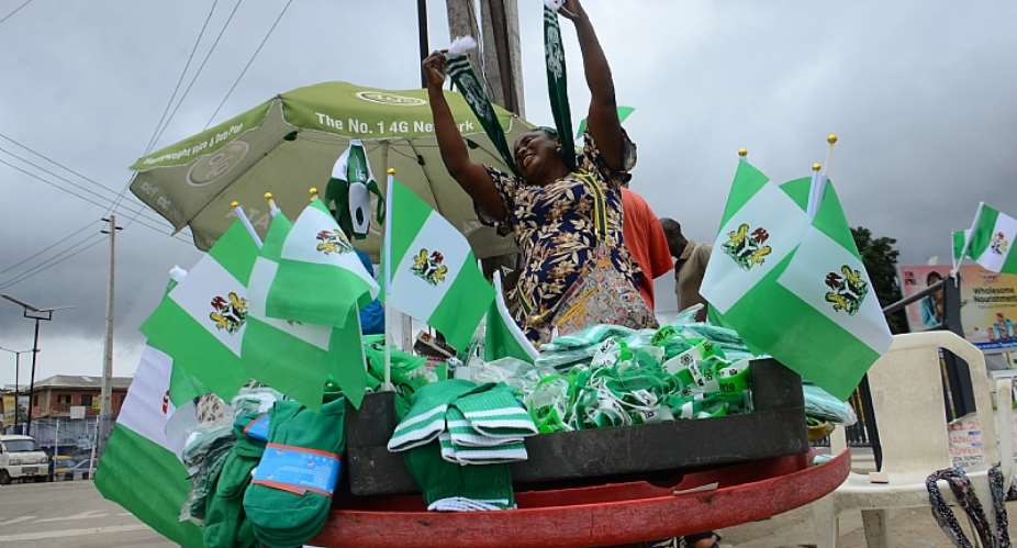 A woman selling Nigerian flags in preparation for Nigeriaamp;39;s independence anniversary in Lagos  on September 30, 2020. Photo by Olukayode JaiyeolaNurPhoto via Getty Images. - Source: