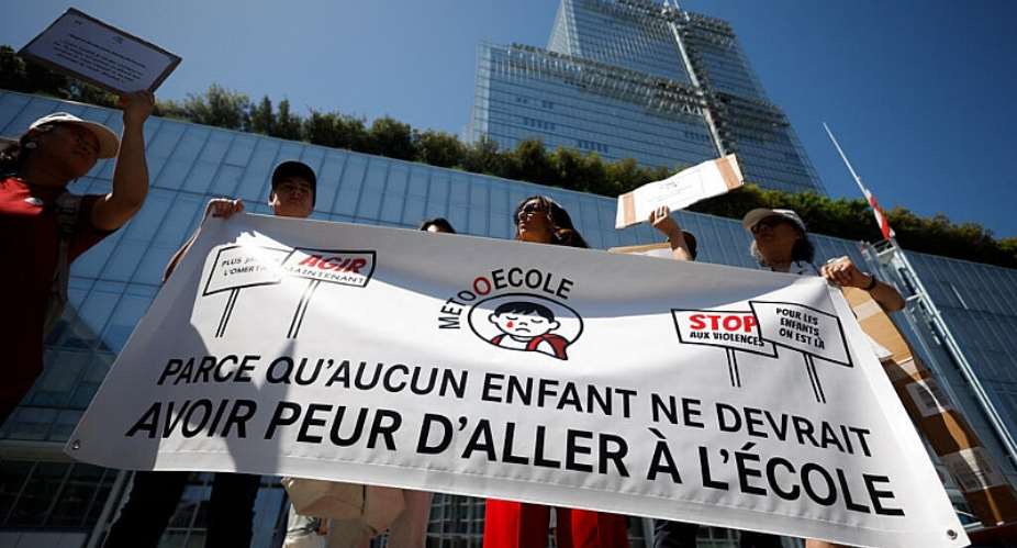 No child should be afraid to go to school, reads a banner held by families from the MeTooEcole collective alleging their children were abused during after-school care in Paris, at a protest in front of the Justice Ministry in May 2026. -  AFP - SIMON WOHLFAHRT