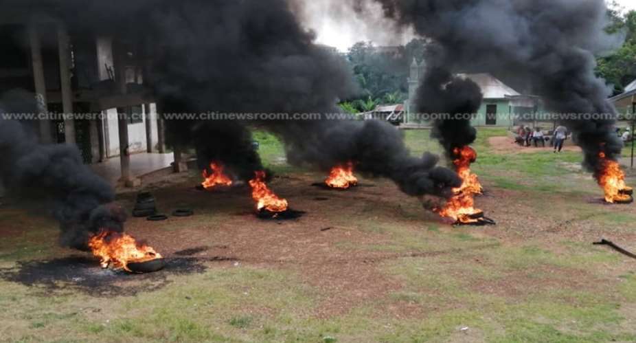 Supporters Of Disqualified Asawase Aspirant Burn Tyres At NDC Party Office
