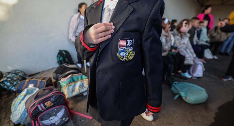 A pupil poses in uniform in the courtyard of the Chateau de la Chevaliere primary school in Beziers on 26 February 2024, as schools across France began trying out uniforms for their students. -  AFP Pascal Guyot