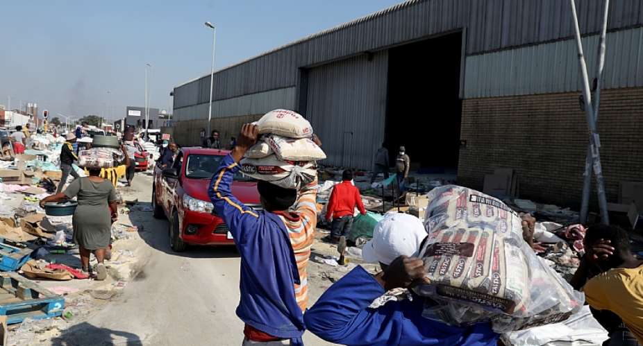 Looters make off with supplies during the unrest that hit parts of two provinces in South Africa in July.  - Source: EFE-EPAStringer