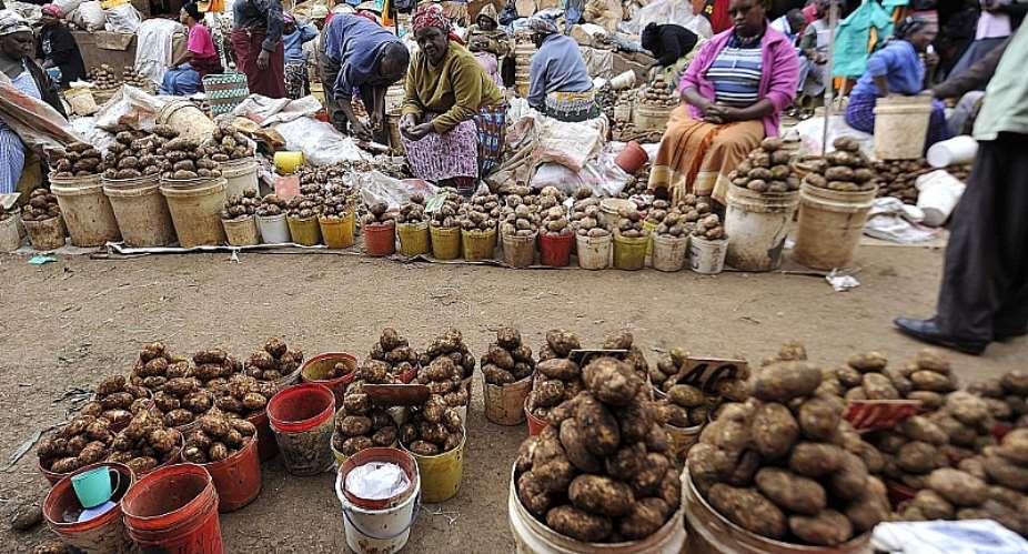 Vendors sell potatoes in a street market on the outskirts of Nairobi. - Source: SIMON MAINAAFP via Getty Images