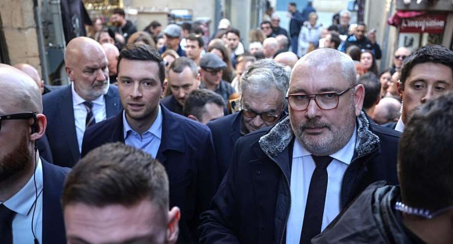 President of the far-right RN party Jordan Bardella walks next to RN mayor of Carcassonne Christophe Barthes on February 7, 2026. -  Valentine Chapuis, AFP