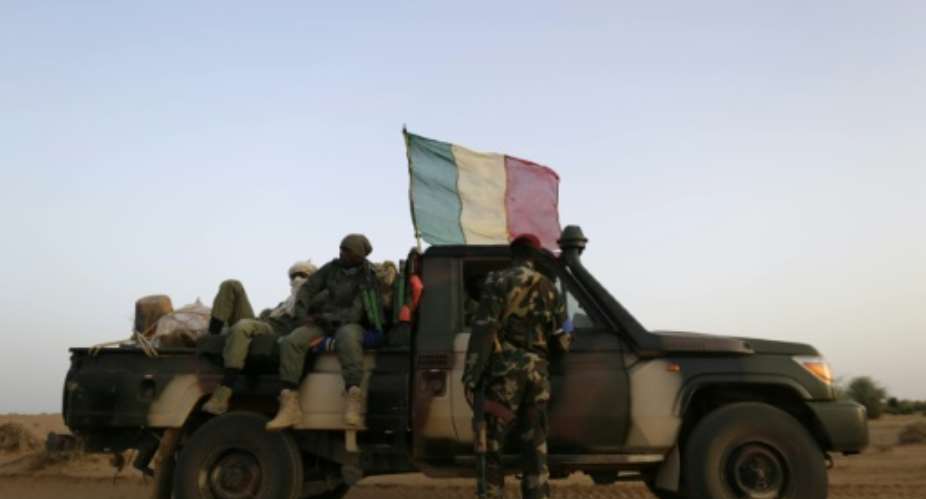 Malian soldiers patrol on a road between Gao and Kidal on July 26, 2013 in northern Mali.  By Kenzo Tribouillard AFPFile
