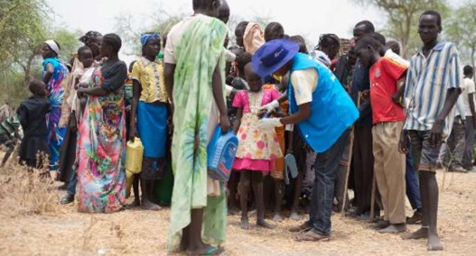 UN officials register new Internally Displaced People IDP as they arrive on May 2, 2015 in Kuernynag in South Sudan's Jonglei State.  By Charles Lomodong AFP